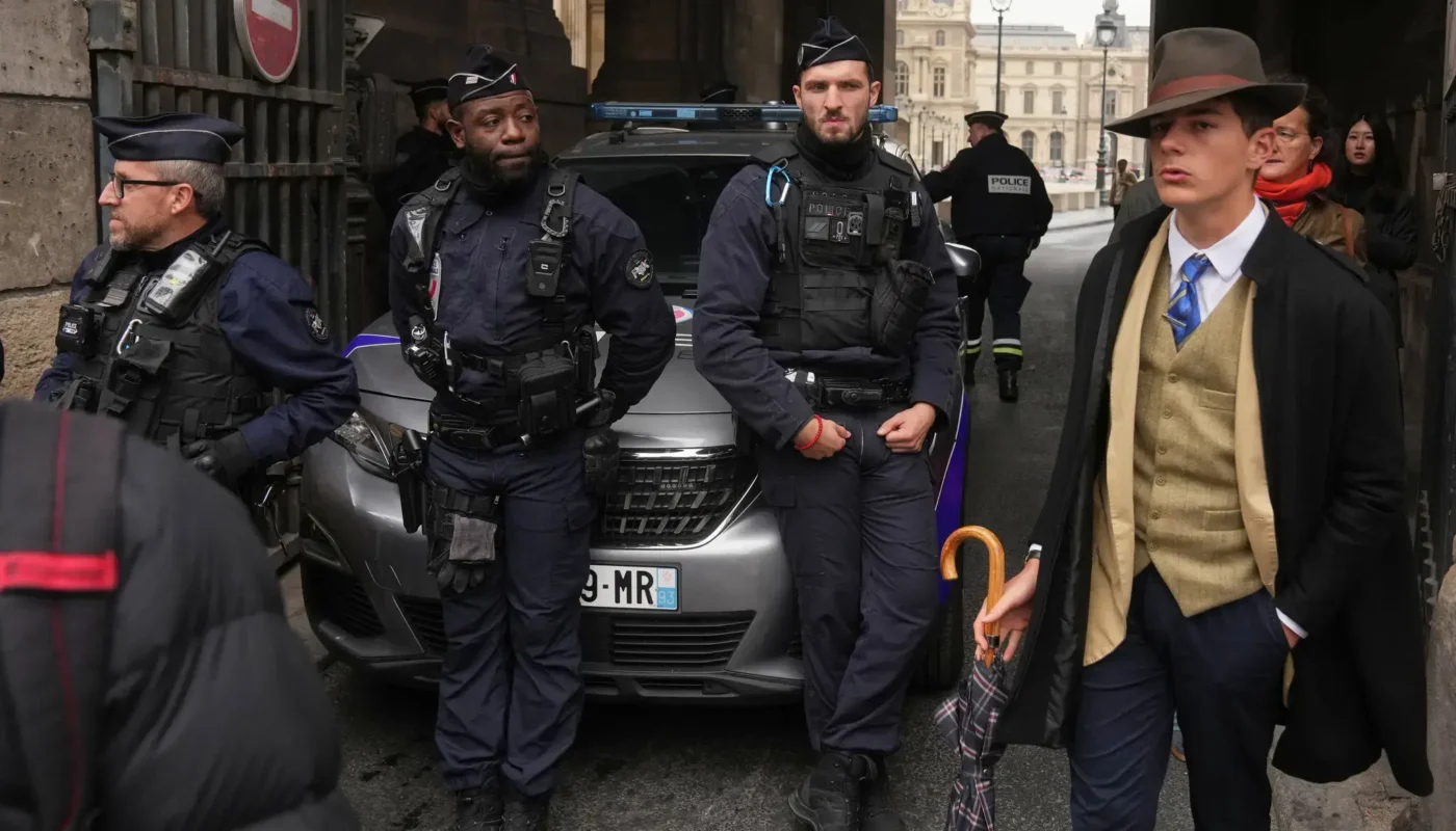In a scene that confused many people on social media, a sharply-dressed man walked near police officers blocking an entrance at the Louvre on Sunday.