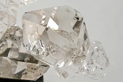Clear Herkimer-style quartz crystals showing natural facets and shine.